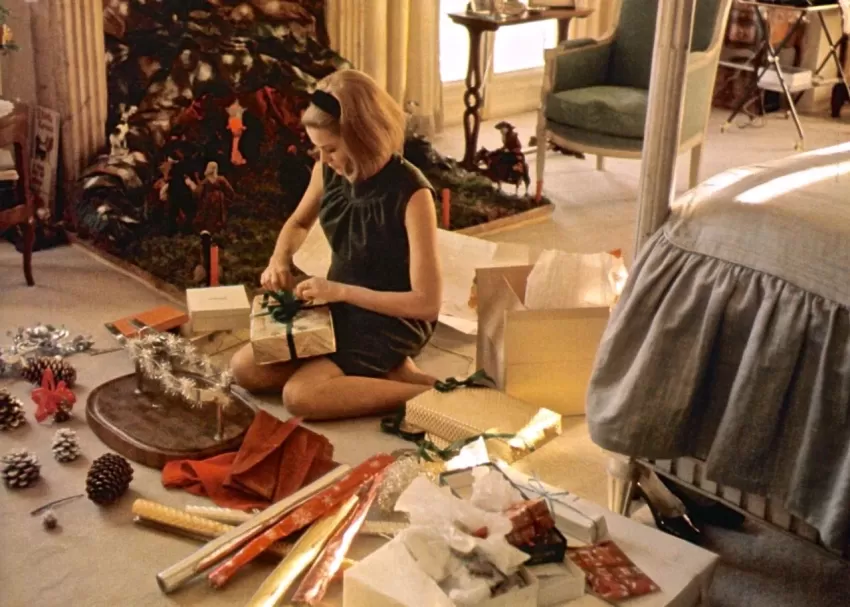 Grace Kelly prepares Christmas presents on the floor of her bedroom